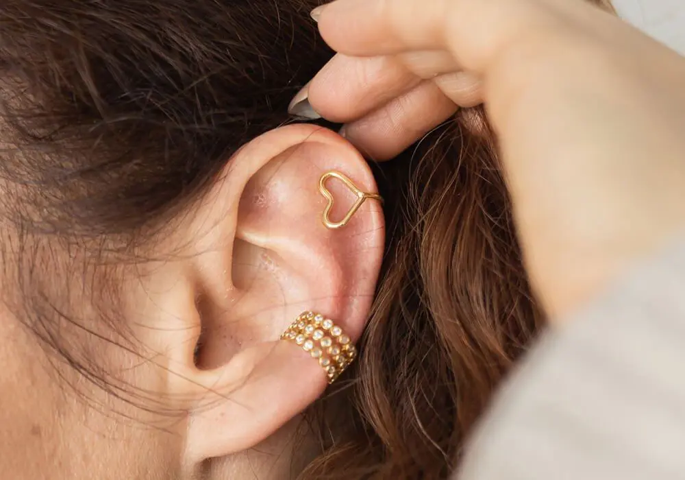 Close-up of gold earrings on an ear