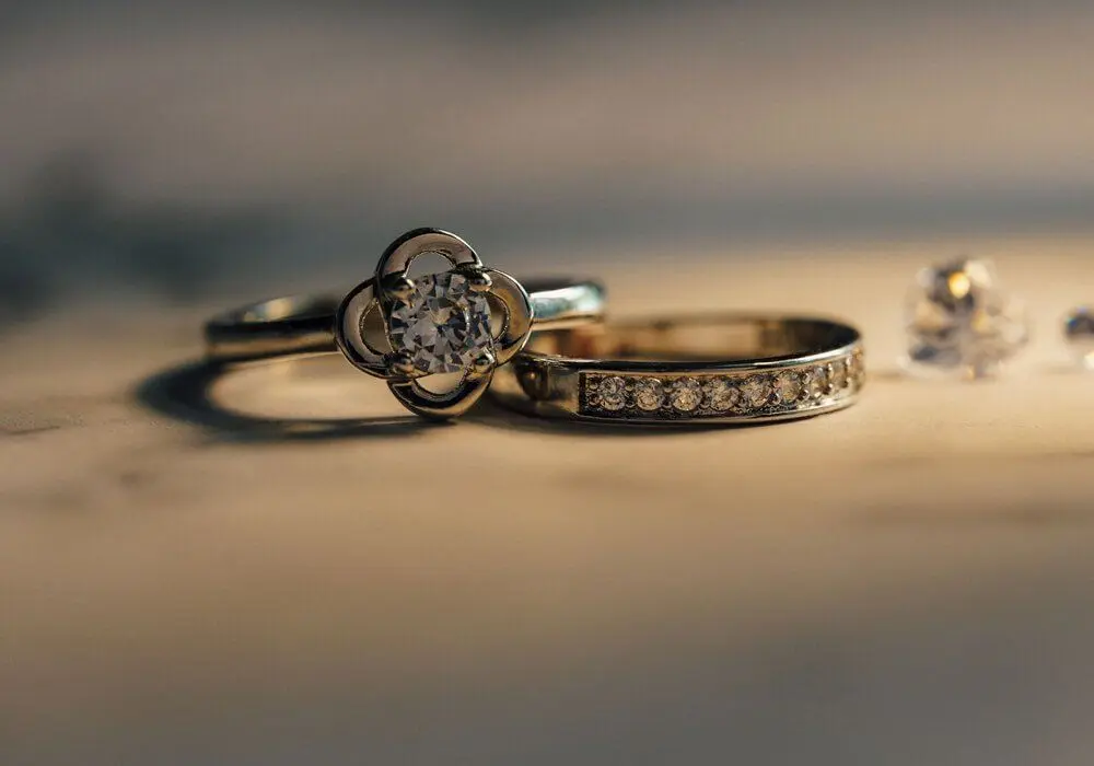 Two gold rings on a dark surface