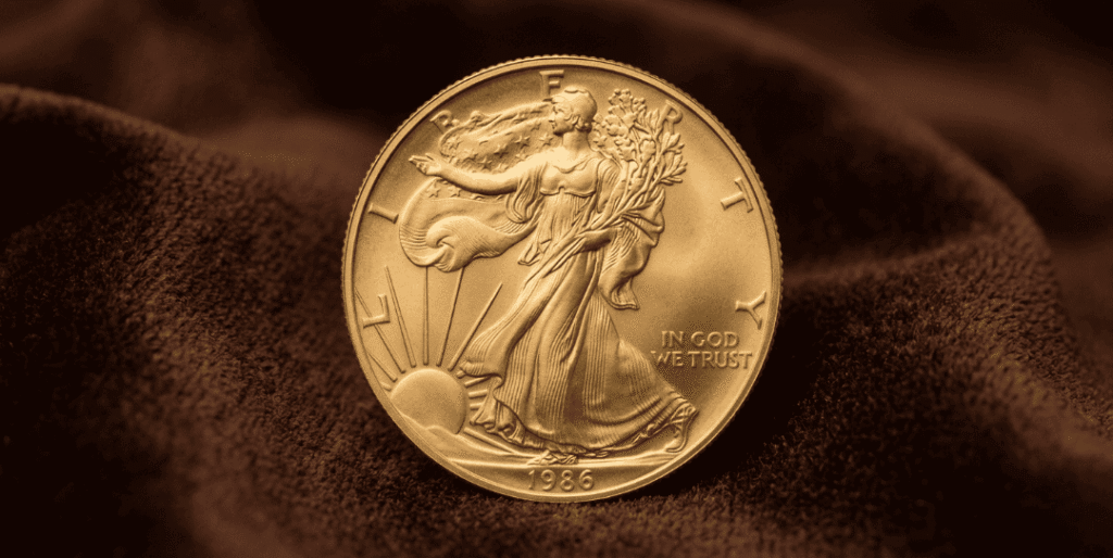 A large, detailed close-up of a Gold American Eagle coin centered on a rich dark brown velvet background, highlighting the iconic Walking Liberty design and 1986 mint mark.