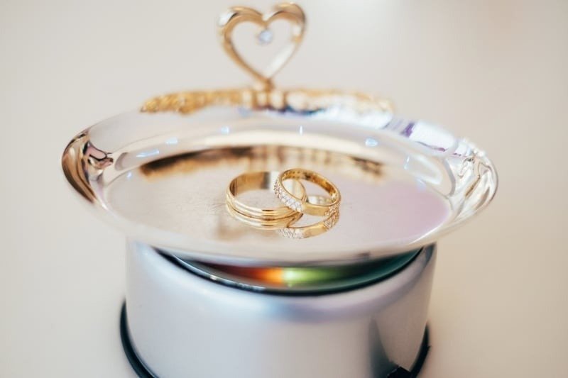 Two elegant rings resting on a reflective silver display dish, perfectly illustrating the exquisite Gold Ring Styles you can discover using our expert Gold Rings Guide before you decide to Buy Gold Rings Little Rock.